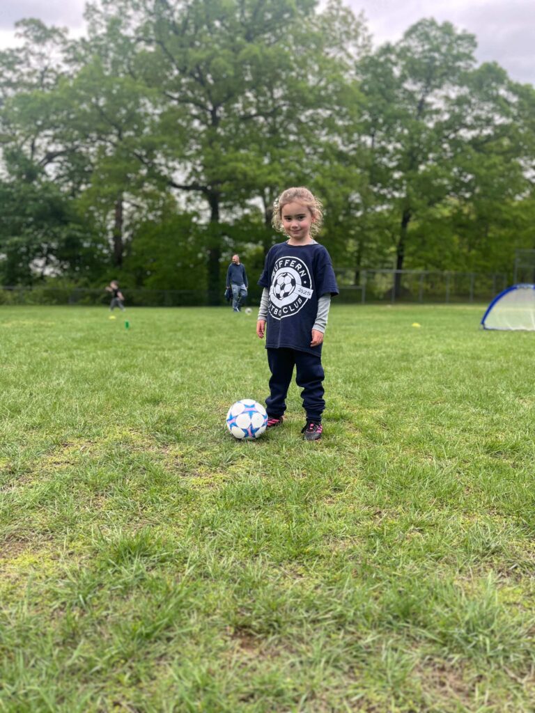 Suffern FC Player standing with ball